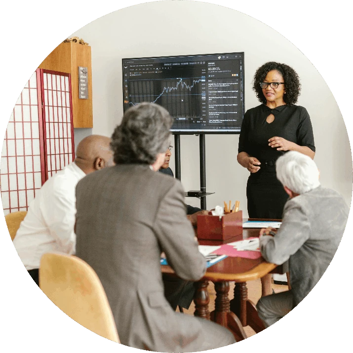Staff member presenting to healthcare leaders at a meeting